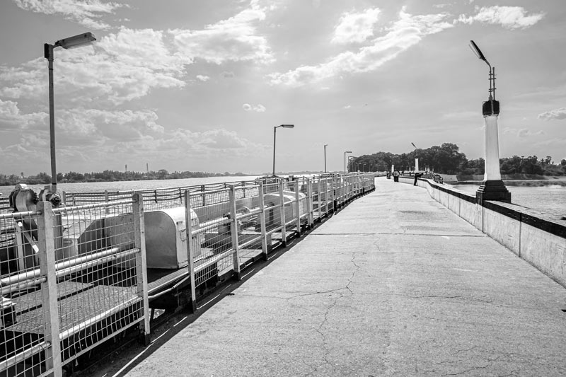 The bridge over historical Grand Anicut, clearly displaying the serpentine shape of the structure - in Thanjavur district, Tamil Nadu